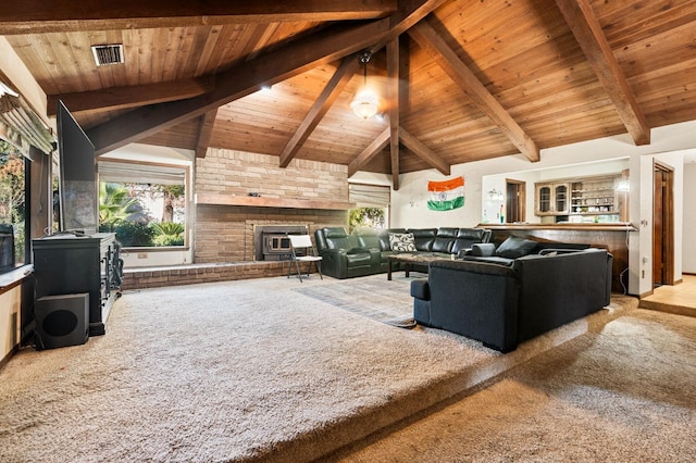 living room with carpet flooring, lofted ceiling with beams, a wood stove, and wood ceiling