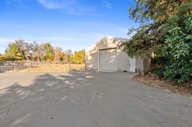 view of property exterior featuring a garage and an outbuilding