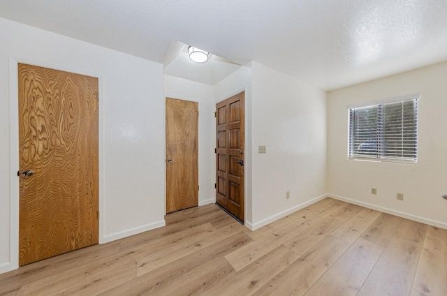 unfurnished room with light hardwood / wood-style floors