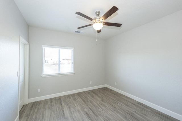 unfurnished room featuring hardwood / wood-style floors and ceiling fan