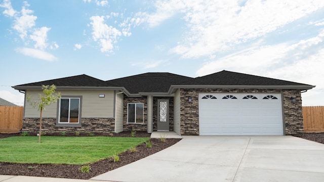 view of front of home featuring a garage and a front lawn