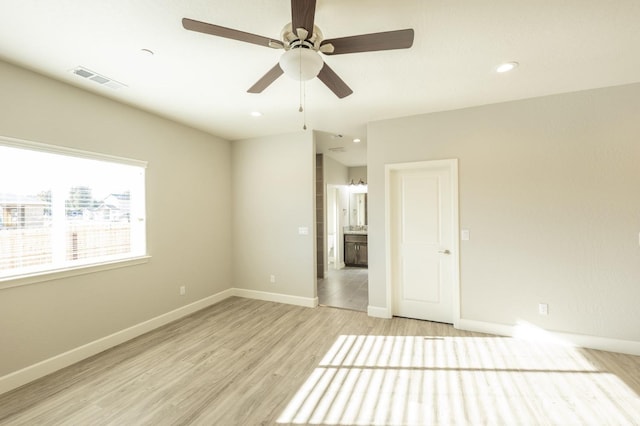 spare room featuring ceiling fan and light hardwood / wood-style flooring