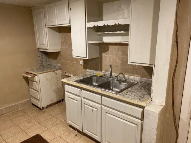 kitchen featuring white cabinetry, sink, tasteful backsplash, and light tile patterned floors