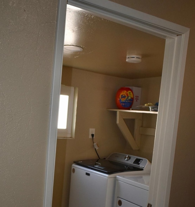 laundry room with washing machine and clothes dryer