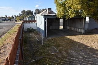 view of side of property with an outdoor structure and a garage