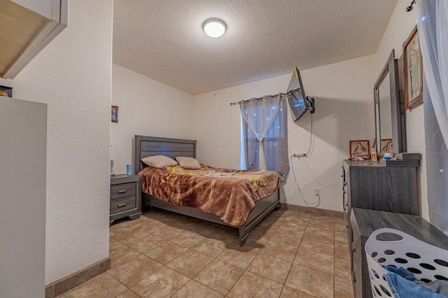 bedroom featuring a textured ceiling and baseboards