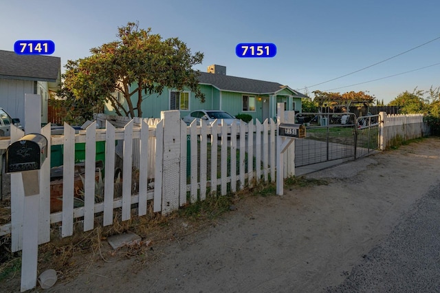 bungalow-style house with fence and a gate