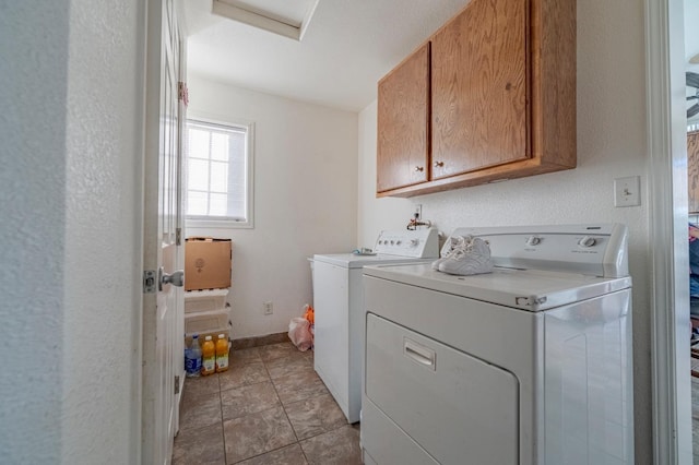 laundry area with attic access, baseboards, cabinet space, and washer and clothes dryer