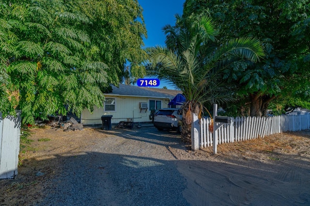 view of front of home with driveway and a fenced front yard