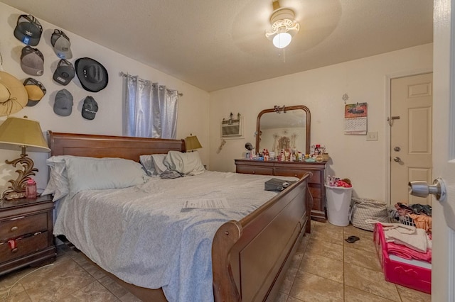 bedroom featuring a ceiling fan, light tile patterned flooring, and a wall mounted air conditioner