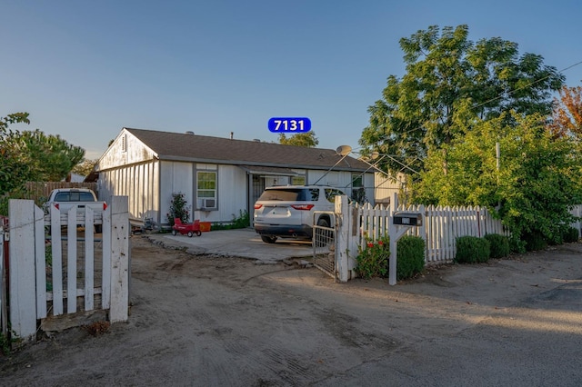 bungalow-style house featuring cooling unit and a fenced front yard
