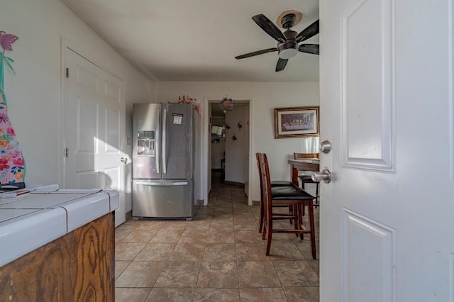kitchen with stainless steel fridge with ice dispenser and ceiling fan