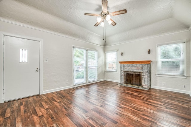 unfurnished living room featuring ceiling fan, dark hardwood / wood-style floors, and a textured ceiling