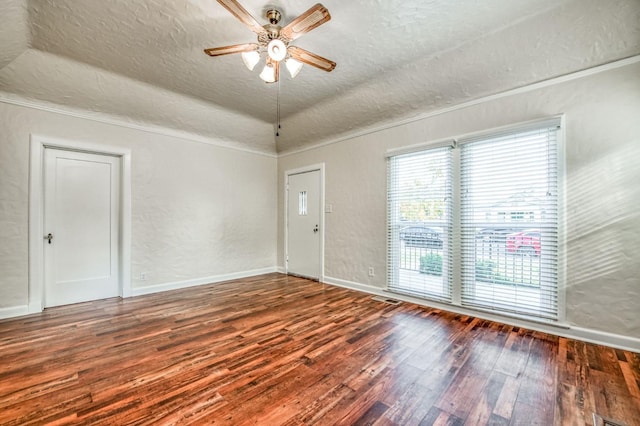 spare room featuring ceiling fan, dark hardwood / wood-style floors, vaulted ceiling, and a textured ceiling