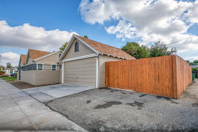 view of side of home featuring a garage