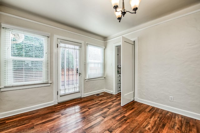 entryway featuring dark hardwood / wood-style flooring and an inviting chandelier