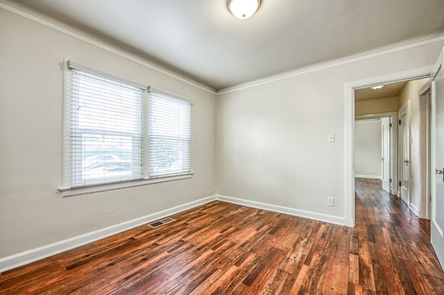 unfurnished room with crown molding and dark wood-type flooring