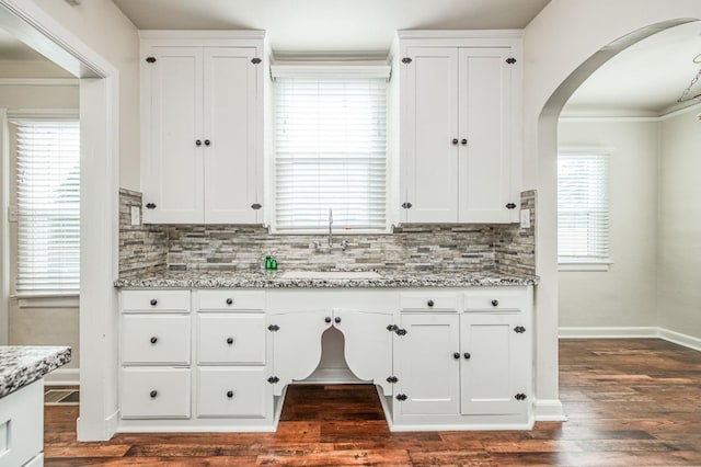 kitchen featuring light stone countertops, white cabinets, and dark hardwood / wood-style flooring