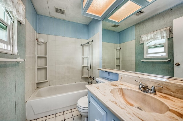 full bathroom with toilet, vanity, tile patterned floors, and tiled shower / bath