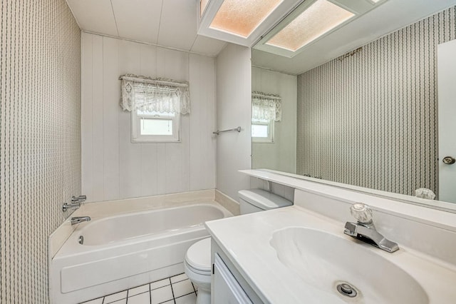 bathroom with vanity, toilet, tile patterned floors, and a bathing tub