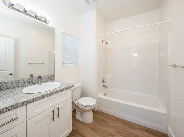 full bathroom featuring hardwood / wood-style floors, shower / bath combination, toilet, and vanity