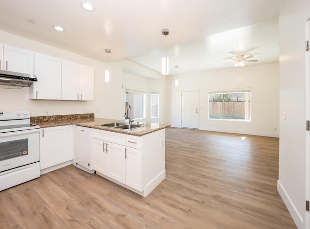 kitchen with sink, kitchen peninsula, hanging light fixtures, white appliances, and ventilation hood