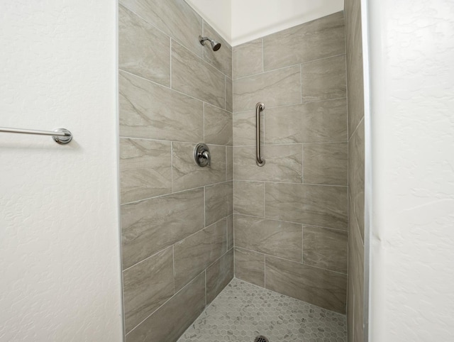 bathroom with tiled shower