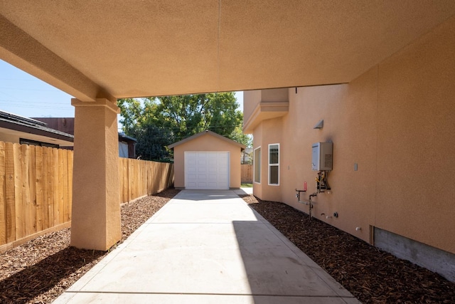 view of patio featuring a garage and an outdoor structure