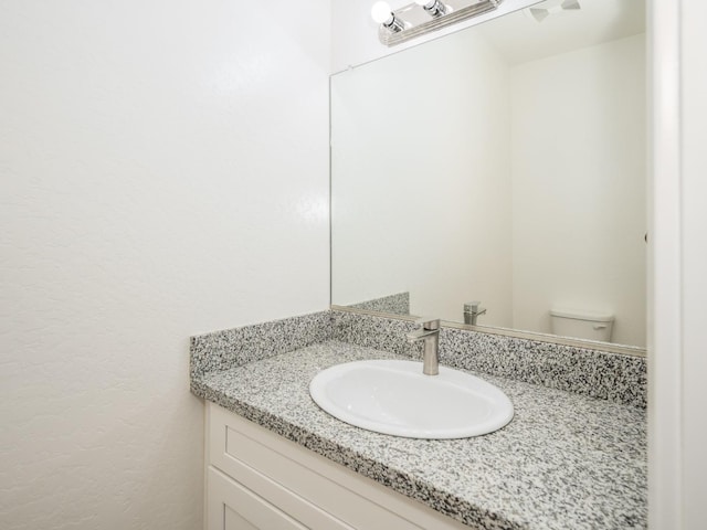 bathroom with toilet and vanity