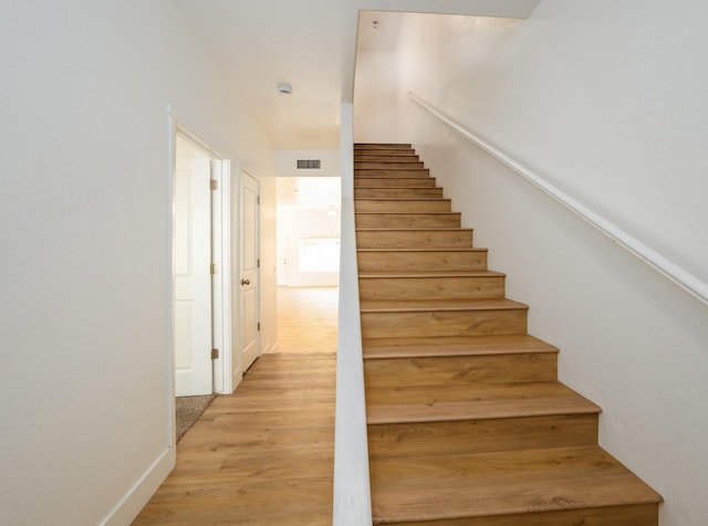 stairway with hardwood / wood-style floors