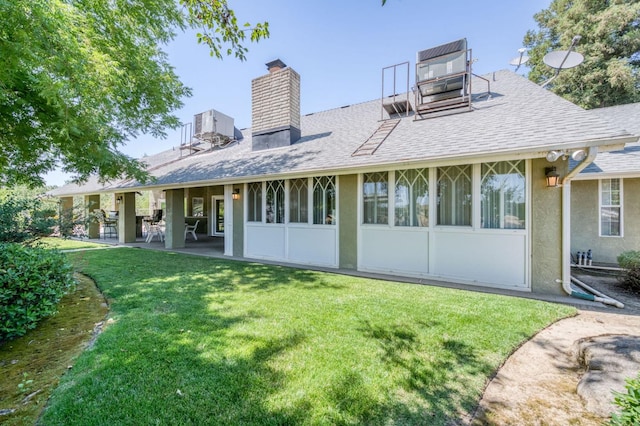 11333 E Church Ave, Sanger, CA 93657 - rear view of property with a chimney, a shingled roof, a yard, and stucco siding