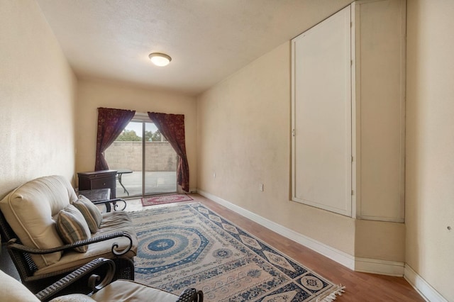 sitting room with a textured ceiling and light hardwood / wood-style flooring