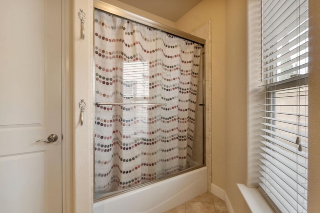 bathroom featuring shower / bath combination with glass door and tile patterned flooring