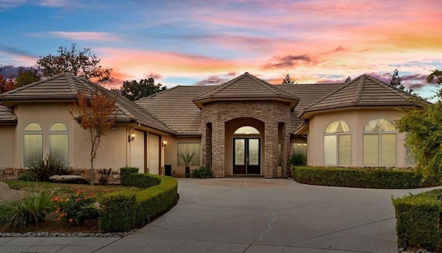 view of front facade featuring a garage and french doors