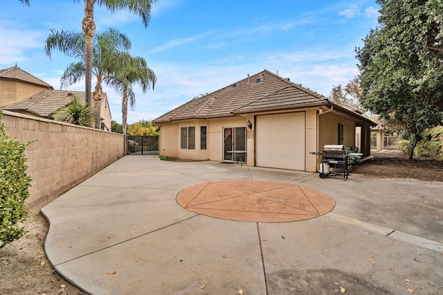 back of property featuring a garage