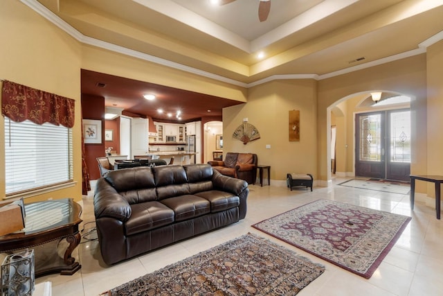 living room with french doors, light tile patterned floors, ceiling fan, and crown molding