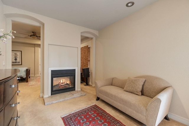 carpeted living room featuring ceiling fan