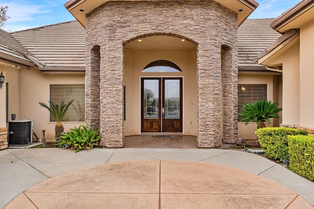 entrance to property with central AC unit and french doors