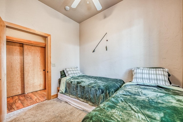 bedroom with a closet, carpet, vaulted ceiling, and ceiling fan