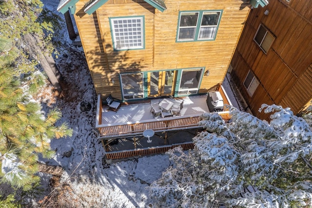 rear view of property featuring a deck