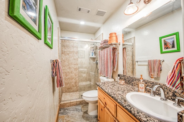 bathroom with walk in shower, vanity, and toilet