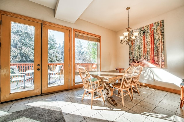 dining space with light tile patterned flooring and a chandelier