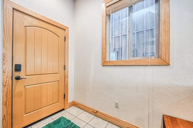 entryway with light tile patterned floors