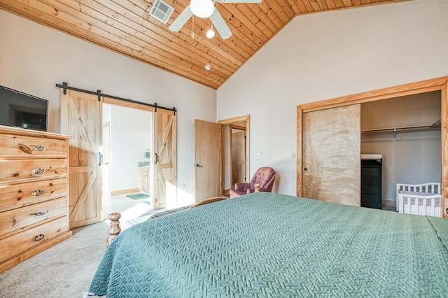 carpeted bedroom with a closet, a barn door, high vaulted ceiling, wooden ceiling, and ceiling fan