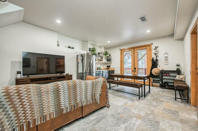 bedroom featuring sink, access to exterior, french doors, stainless steel fridge, and vaulted ceiling