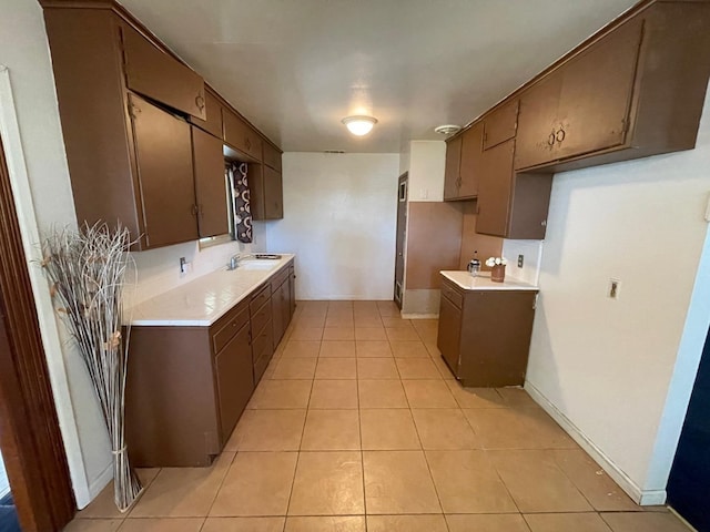 kitchen with sink and light tile patterned flooring