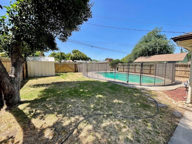 view of yard with a fenced in pool and a storage shed