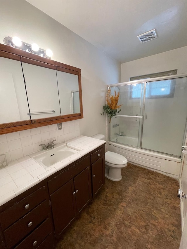 full bathroom with vanity, backsplash, toilet, and enclosed tub / shower combo