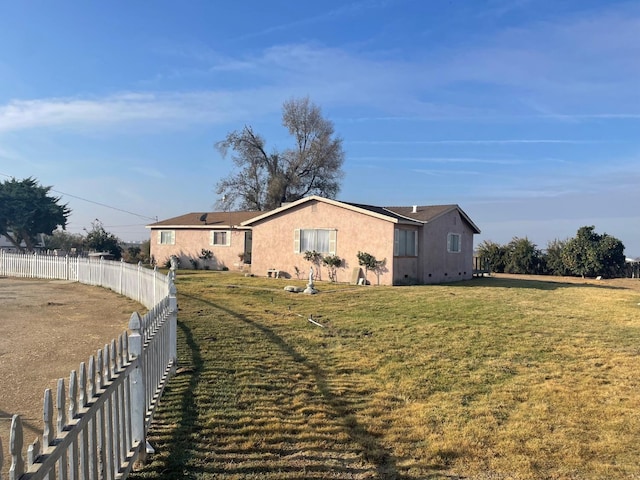 view of side of home featuring a yard