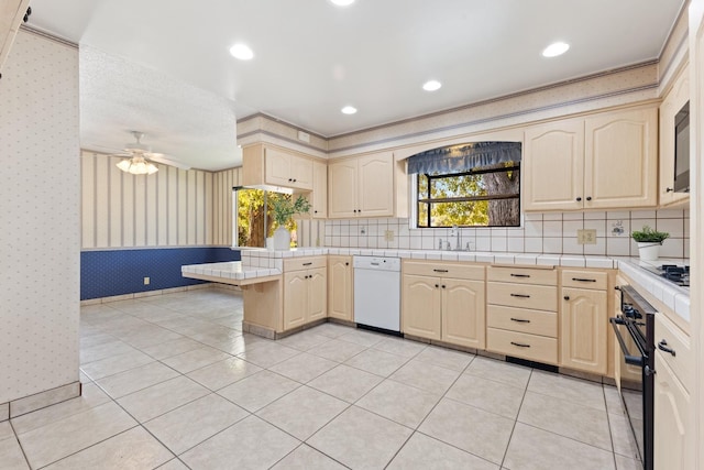 kitchen featuring sink, light tile patterned floors, white dishwasher, and kitchen peninsula